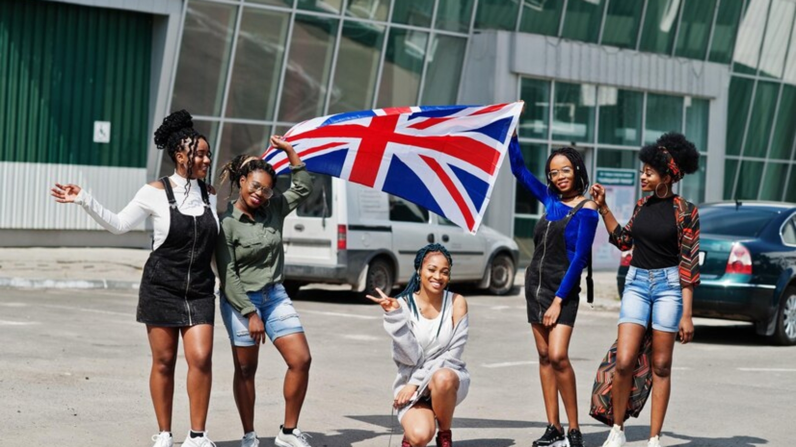 group-five-african-american-woman-walking-together-parking-with-great-britain-flag_627829-503